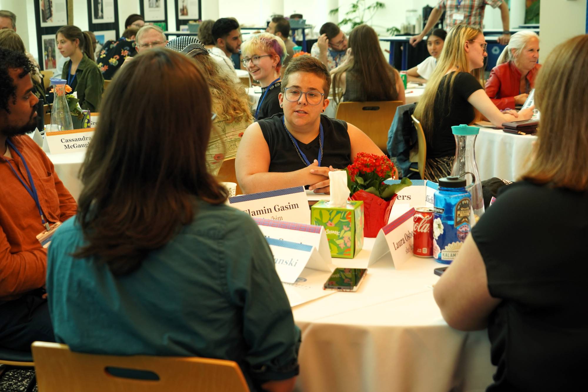 Group of people engaged in conversation around a table